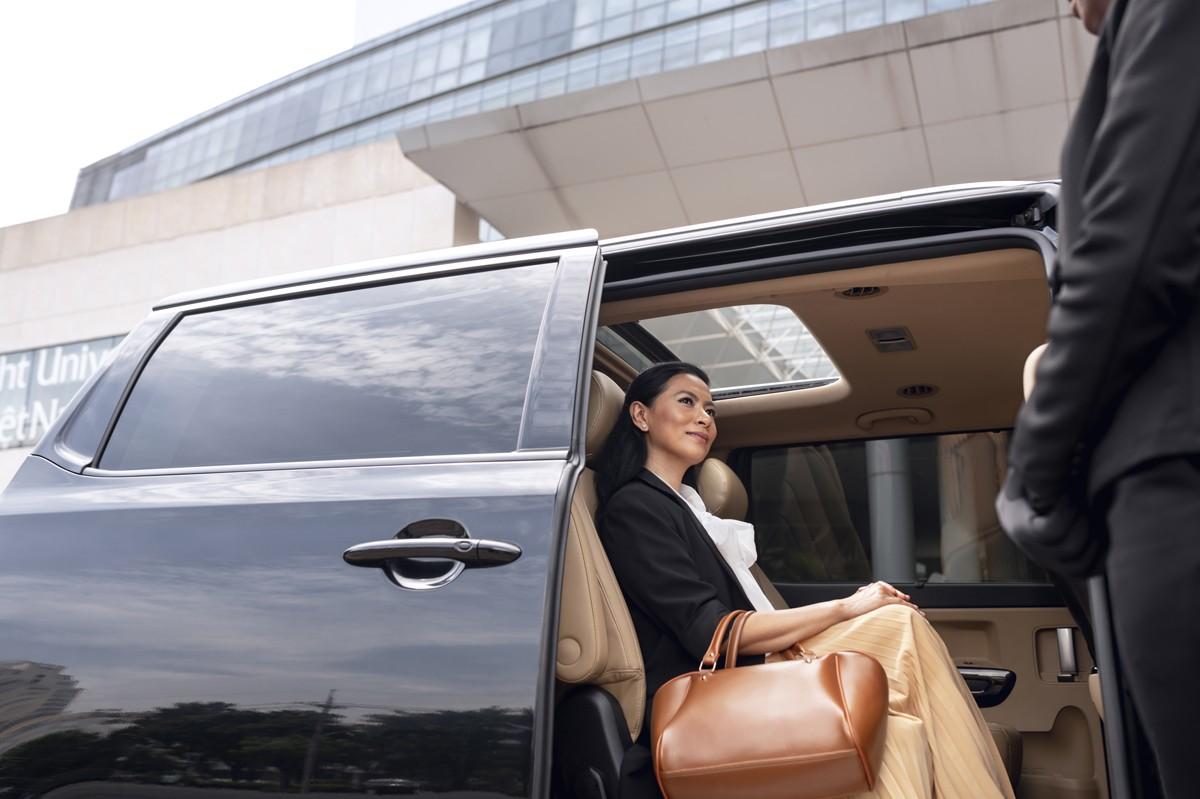 Woman relaxing in the back seat of Blue Shuttle Van